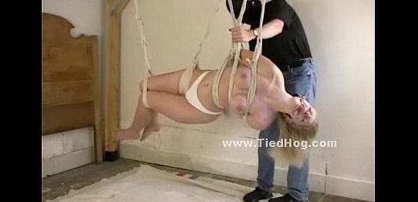  Submissive woman is tied to a cross